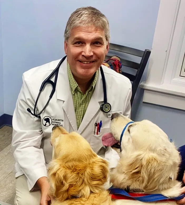 Dr. Daniel Smith holding a happy puppy